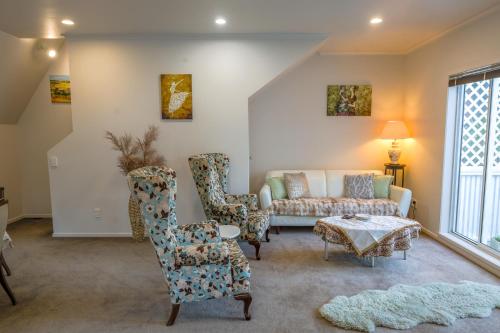 a living room with a couch and chairs at Bolton Executive Residence in Wellington