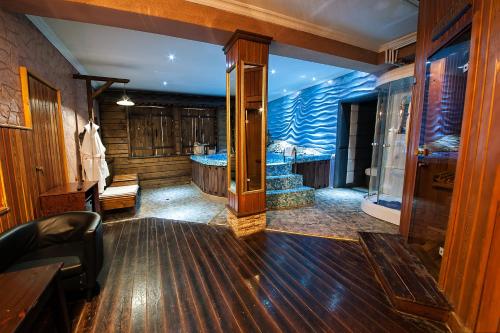 a large bathroom with a tub in a room at Sunflow Park Hotel in Kartmazovo