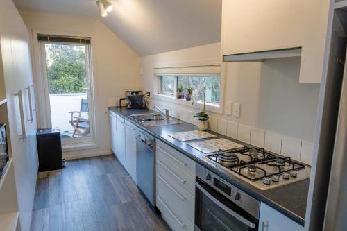 a kitchen with a sink and a stove at Bolton Executive Residence in Wellington
