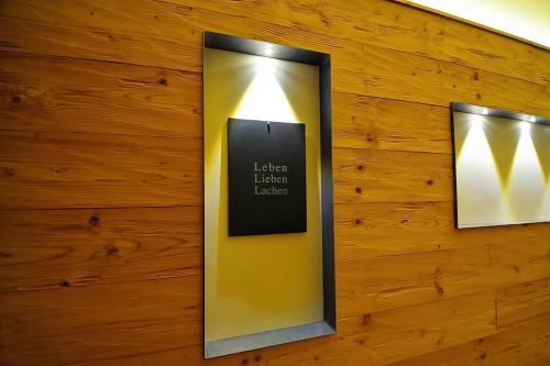 a wall with two mirrors on a wooden wall at 5 Sterne Ferienhaus Bayern in Untergriesbach