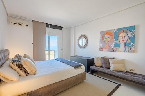 a bedroom with a bed and a couch at Villa Casablanca by Welcome Tenerife in Chayofa
