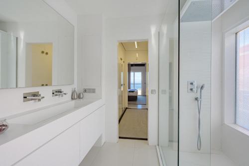 a white bathroom with a shower and a sink at Villa Casablanca by Welcome Tenerife in Chayofa
