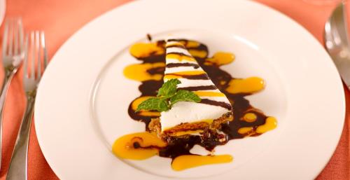 a white plate with a dessert on a table at Hotel English Point Marina & Spa in Mombasa