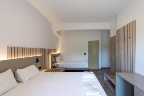 Ένα ή περισσότερα κρεβάτια σε δωμάτιο στο Hotel Agistro