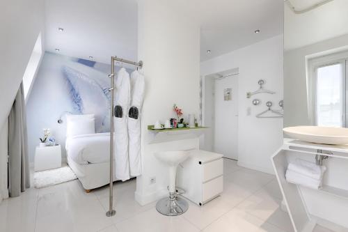 a white bathroom with a sink and a toilet at Blc Design Hotel in Paris