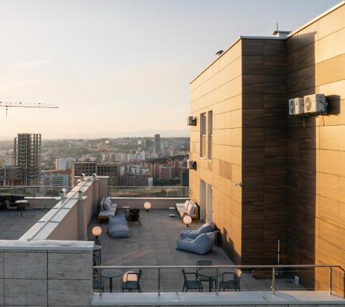 a view of the rooftop of a building with tables and chairs at ETERN Apart-Hotel II in Pristina