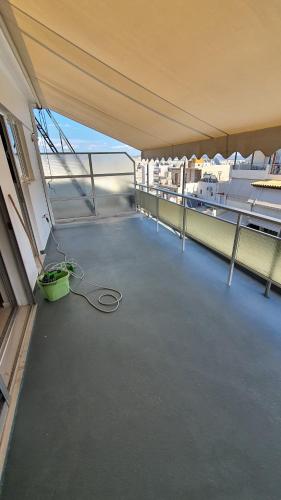 an empty room with a hose on a balcony at Elite Port in Piraeus