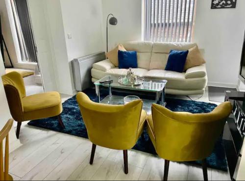 a living room with a couch and yellow chairs at Pudding Chare by Gibson Rentals near train station in Newcastle upon Tyne