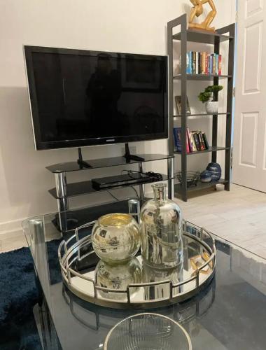 a glass coffee table with a tv in a living room at Pudding Chare by Gibson Rentals near train station in Newcastle upon Tyne