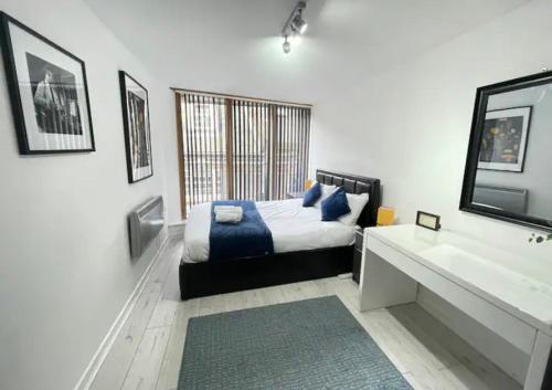 a bedroom with a bed and a sink and a mirror at Pudding Chare by Gibson Rentals near train station in Newcastle upon Tyne