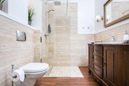 a bathroom with a shower and a toilet and a sink at Executive 2-bedroom Apartment in Krakow