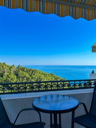 a table and chairs on a balcony with the ocean at Villa Dulsinea in Ulcinj