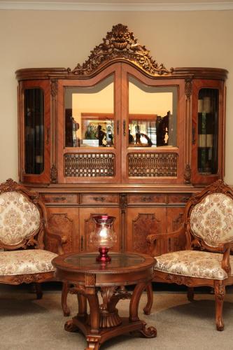 a large wooden hutch with two chairs and a table at Misty Waves Boutique Hotel in Hermanus
