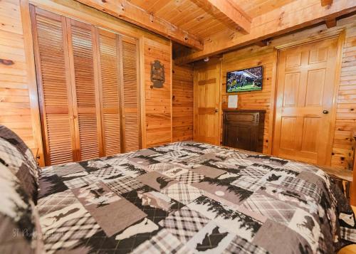 a bedroom with a bed in a wooden cabin at A Slice of Heaven Cabin in Park Settlement