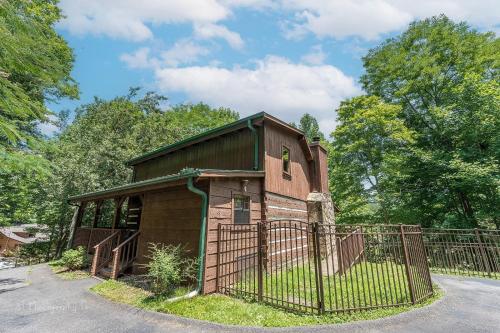a small building with a fence in front of it at A Slice of Heaven Cabin in Park Settlement
