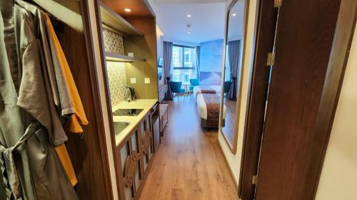 a bathroom with a sink and a bed in a room at APEC Mandala Mũi Né in Mui Ne