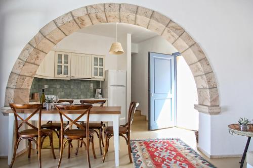 a kitchen and dining room with a table and chairs at Blue Bay Patmos Summer House in Grikos