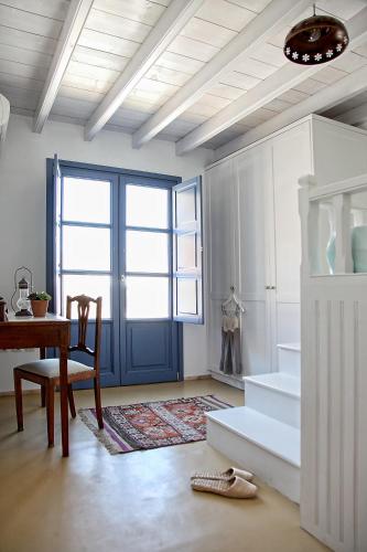 a room with a desk and a table and a window at Blue Bay Patmos Summer House in Grikos