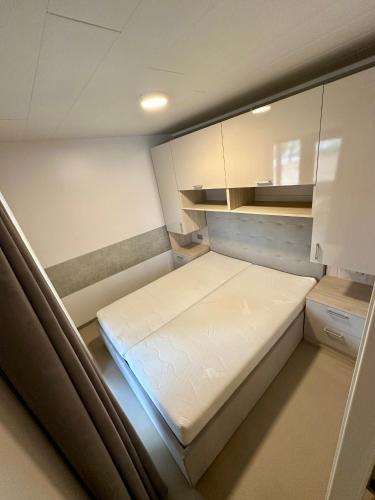 a small room with a bed and cabinets at Sunset Serenity Villas with onsite pool and only 3min from beach in Drage