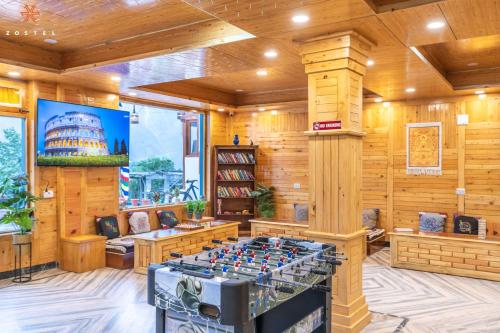 a game room with a foosball table in the middle at Zostel Kalpa in Kalpa