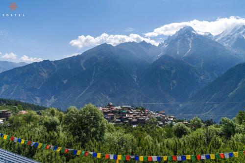 a view of a mountain range with colorful flags at Zostel Kalpa in Kalpa