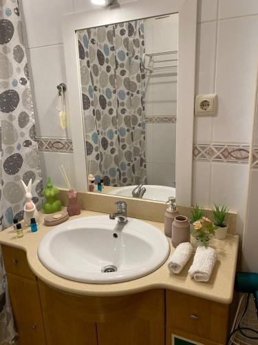 a bathroom with a white sink and a shower at Guesthouse Milagre Centro Faro in Faro