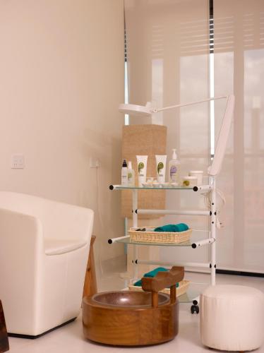a room with a chair and a shelf with products at Hotel English Point Marina & Spa in Mombasa