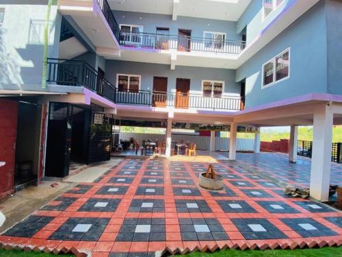 an empty courtyard with a checkered floor in a building at coorg mist greens in Madikeri