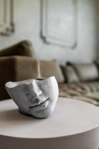 a white bowl sitting on top of a table at ALL - Amberstone Lux Loft in Klaipėda
