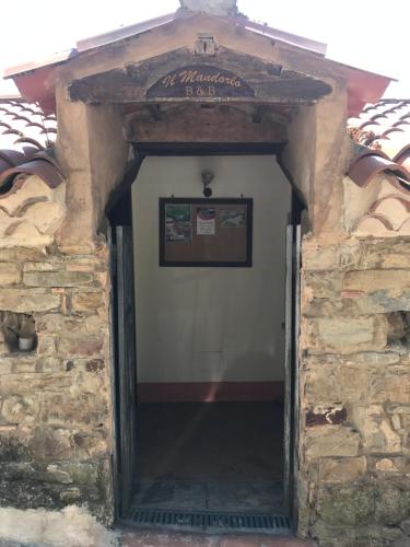 an entrance to a stone building with a white door at Il Mandorlo in Montecorice