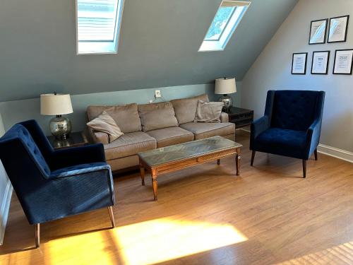 a living room with a couch and two chairs at Bright, big family escape, W/parking, dogs welcome in Oak Park