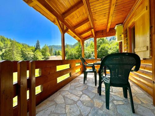 a porch with two chairs and a table at Mountain Retreat Jelovica in Kolašin
