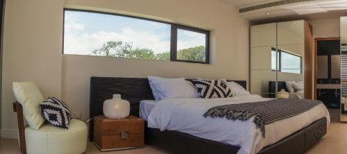 a bedroom with a large bed and a window at Hotel English Point Marina & Spa in Mombasa
