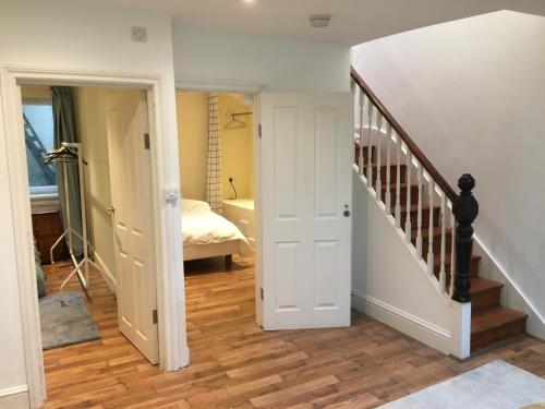 a hallway with a stairway leading to a bedroom at Spacious duplex flat in London