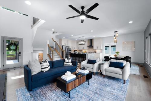 a living room with a blue couch and chairs at Elysian Shores w/Heated Pool & Optional Boat Rental in Mooresville