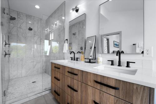 a bathroom with two sinks and a shower at Elysian Shores w/Heated Pool & Optional Boat Rental in Mooresville