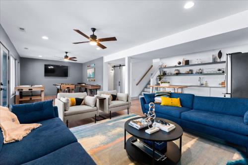 a living room with blue couches and a table at Elysian Shores w/Heated Pool & Optional Boat Rental in Mooresville