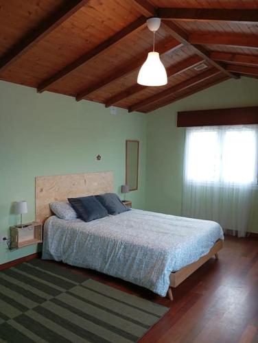 a bedroom with a large bed in a room at A Riquiña in Mondariz