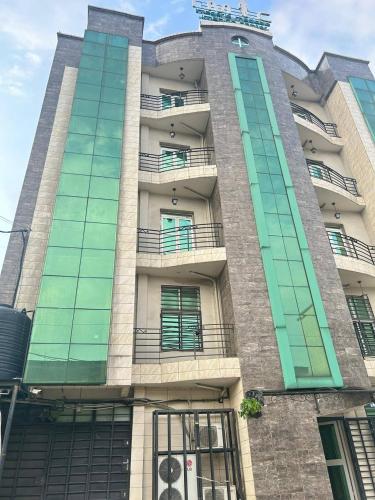 a building with balconies on the side of it at Résidence cosy gold Douala Cameroon in Douala