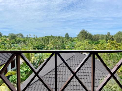 a view from the balcony of a house at Baobab Bungalows in Jambiani