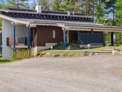 a house with a porch and a driveway at Holiday Home Hiisiranta b3 by Interhome in Kolinkylä