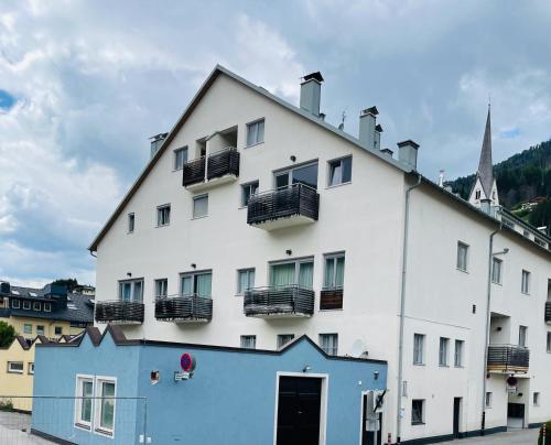 a white building with balconies on top of it at Haus Ruach in Sillian