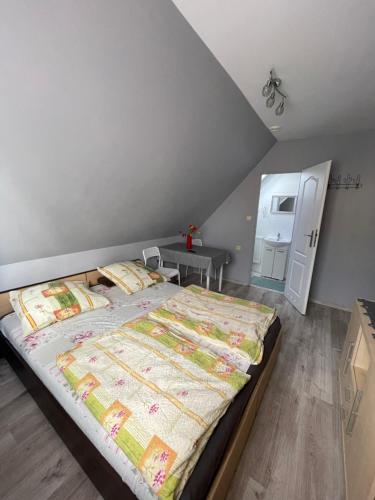 a bedroom with a large bed in a room at Dom Gościnny Tomasz Mielenko in Mielenko