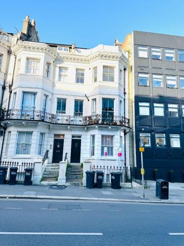 a white building on the side of a street at A modern 2 bedroom seaside apartment in Hastings