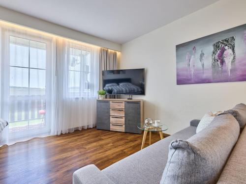 a living room with a couch and a flat screen tv at Apartment Horní Mísečky by Interhome in Vítkovice