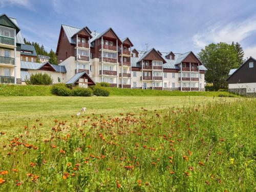 a large apartment building with a field of flowers at Apartment Horní Mísečky-2 by Interhome in Vítkovice