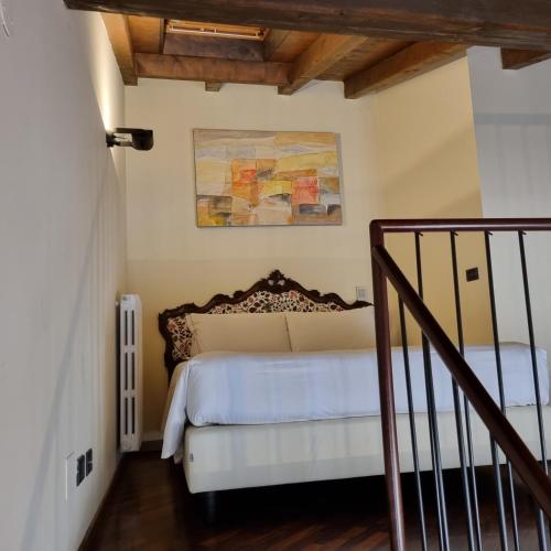 a bedroom with a bed and a painting on the wall at Phi Hotel Bologna in Bologna