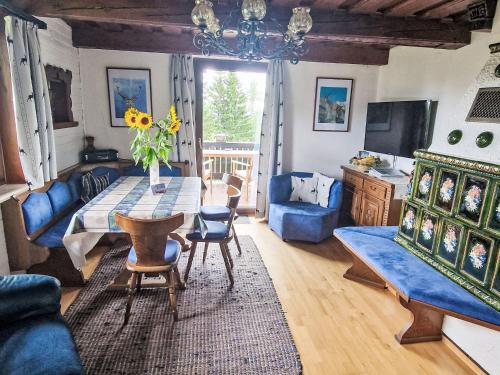 salon ze stołem i wazą kwiatów w obiekcie Holiday Home Lotte by Interhome w mieście Sirnitz-Sonnseite