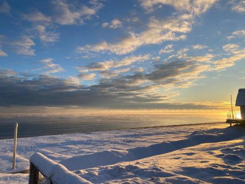 a beach covered in snow next to the water at Strandbude-Scharbeutz 30 m vom Strand in Scharbeutz
