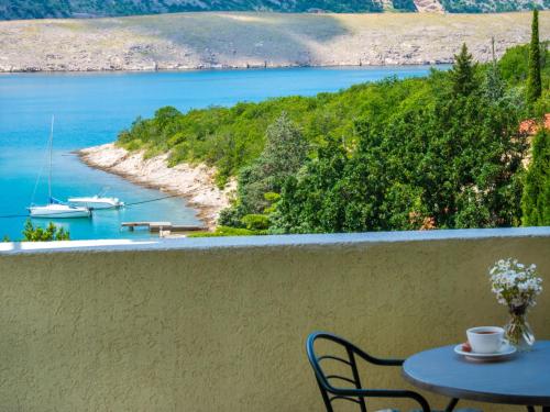 a table and chairs on a balcony overlooking a body of water at Apartment Vlasta-1 by Interhome in Jadranovo